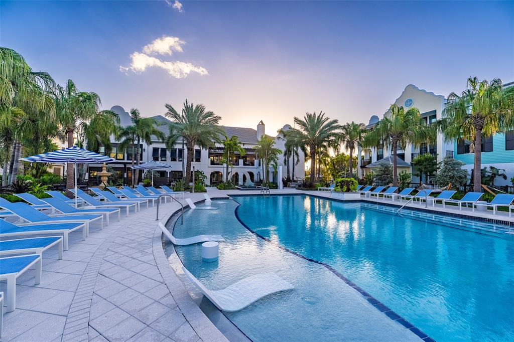 10535 Hamilton Dawn Street, Unit 15300 Orlando, FL 32821 - Photo 6 of 20 a view of a swimming pool with outdoor seating and plants