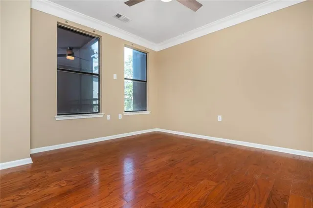 wooden floor in an empty room with a window