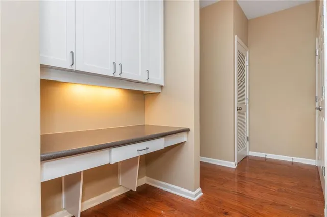 a view of room with wooden floor