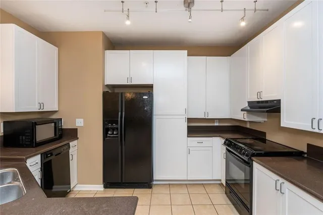 a kitchen with granite countertop a stove and a refrigerator