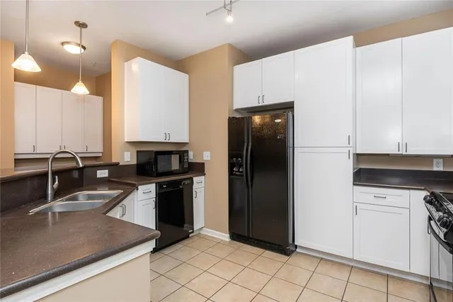 a kitchen with a sink cabinets and stainless steel appliances