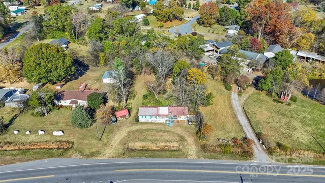 an aerial view of residential houses with yard