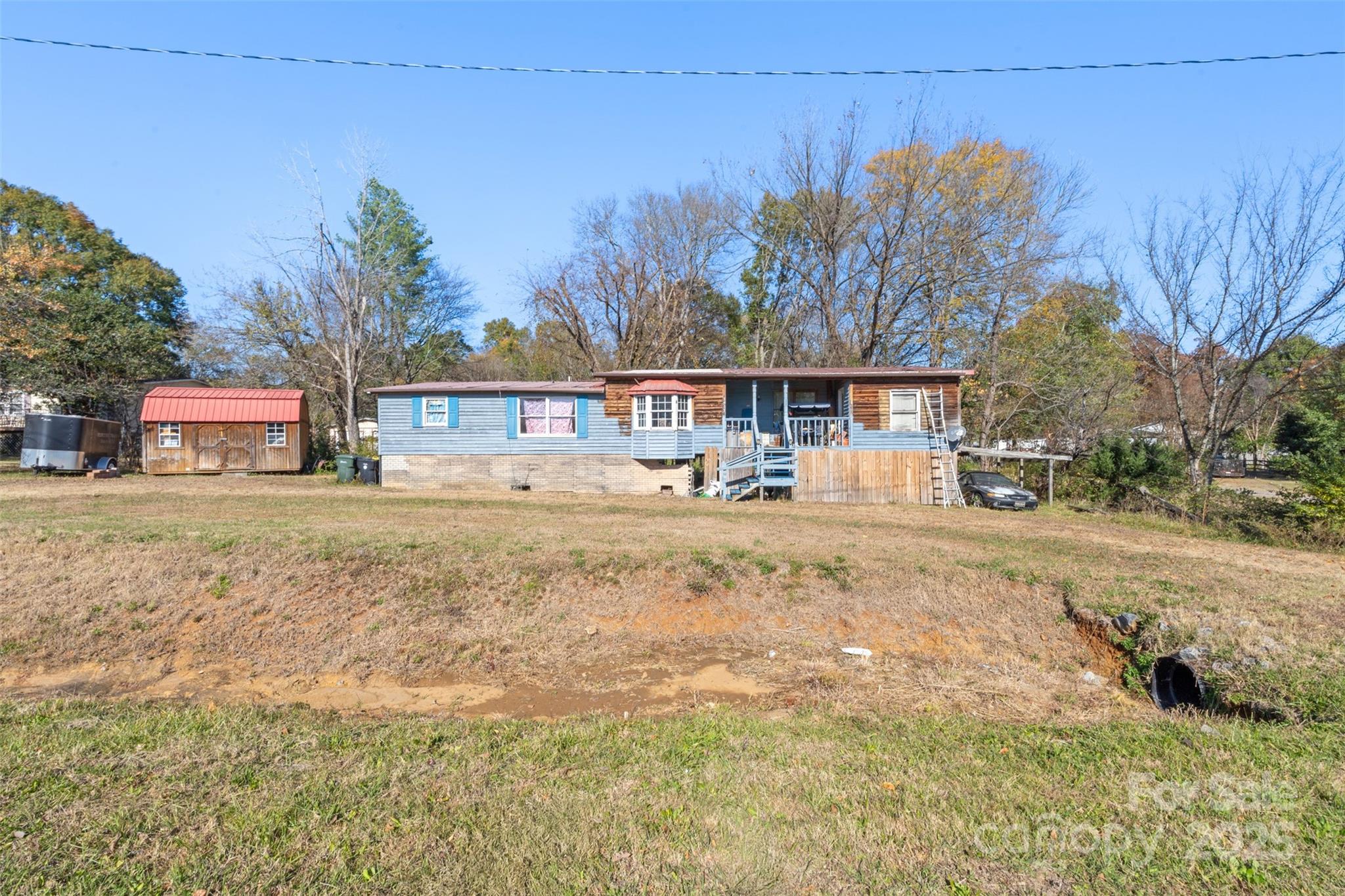 3913 Stough Road Concord, NC 28027 - Photo 14 of 20 a view of large house with a yard