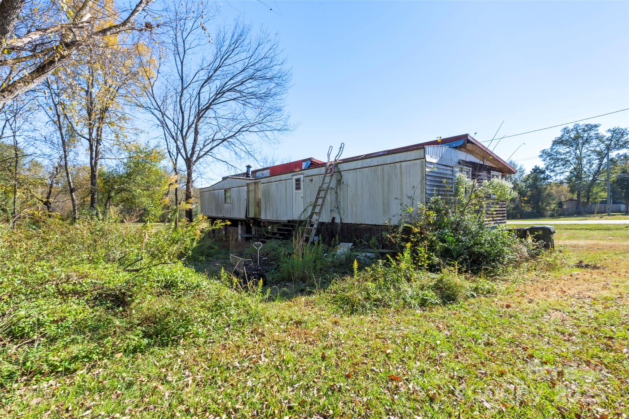 3913 Stough Road Concord, NC 28027 - Photo 17 of 20 a tall yellow house with trees in front of it