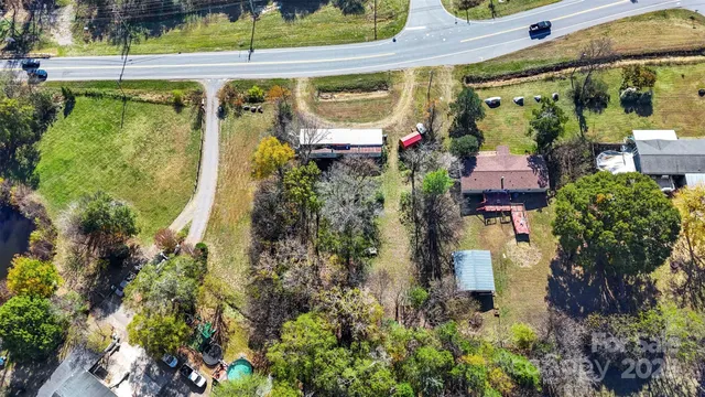 front view of a house with a dirt yard