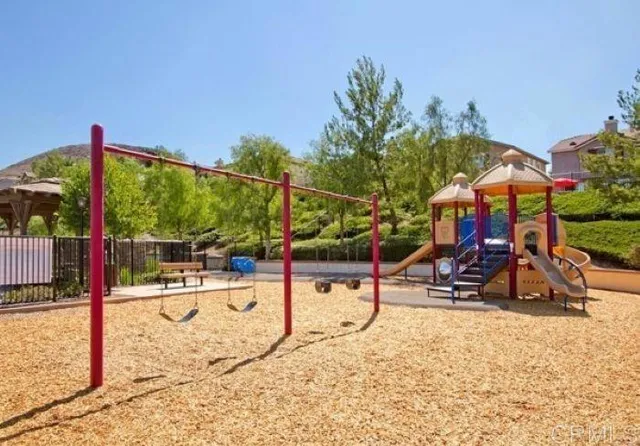 a view of a park with swings and slides