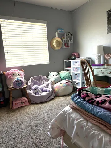 a bedroom with two beds and a window