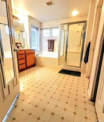 a bathroom with a tub sink and a mirror