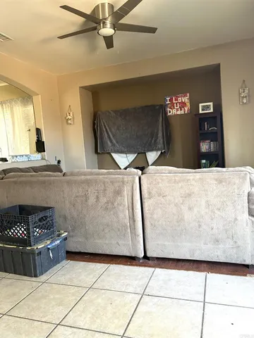 a living room with granite countertop a couch and a stove top oven