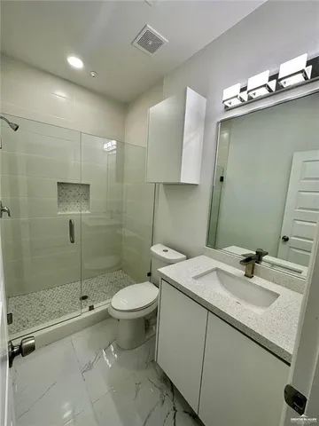 a bathroom with a sink toilet and shower