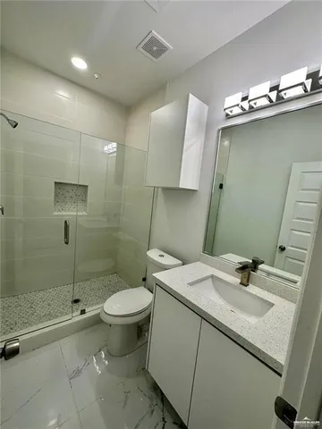 a bathroom with a sink toilet and shower