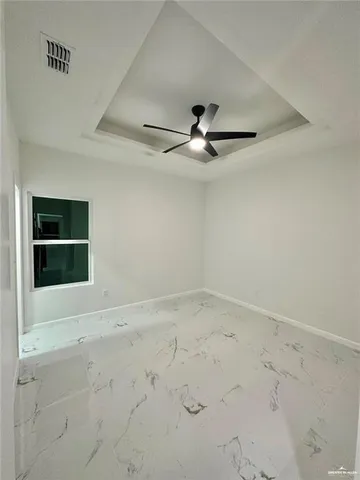 an empty room with a empty space and a ceiling fan