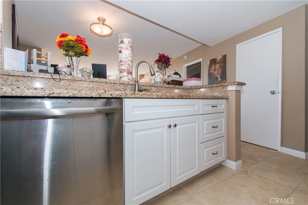 700 East Ocean Boulevard, Unit 706 Long Beach, CA 90802 - Photo 13 of 31 a bathroom with a granite countertop sink a large mirror and vanity