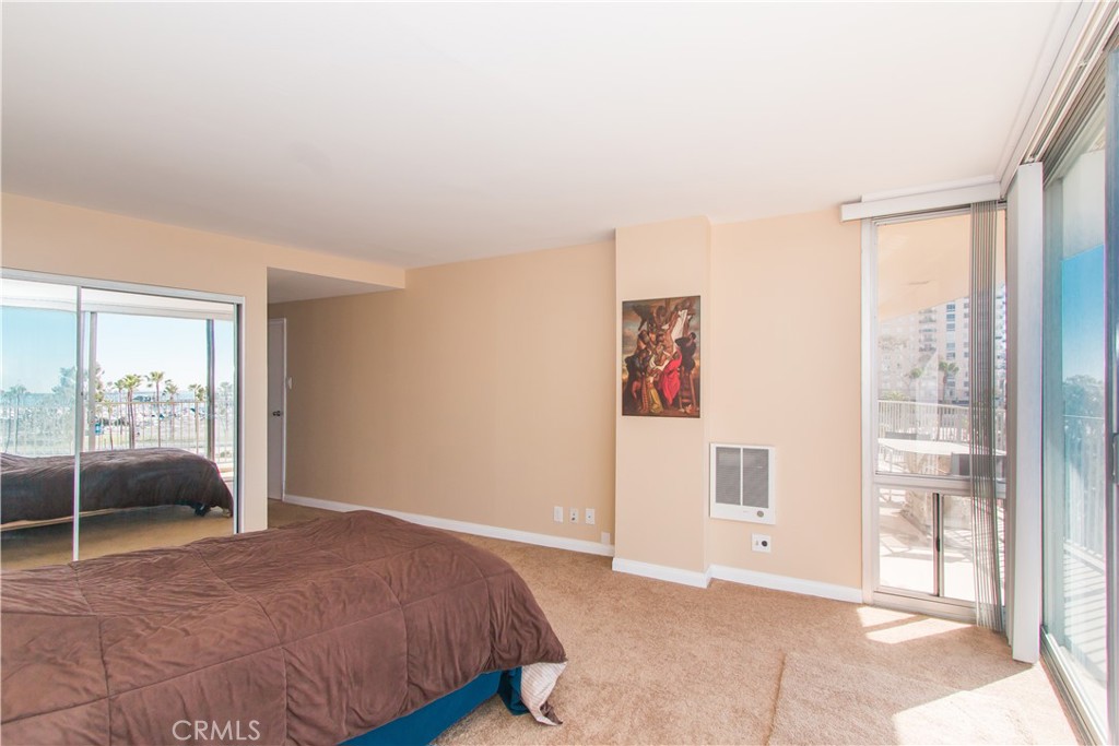 700 East Ocean Boulevard, Unit 706 Long Beach, CA 90802 - Photo 20 of 31 a bedroom with a bed and a large window with balcony view