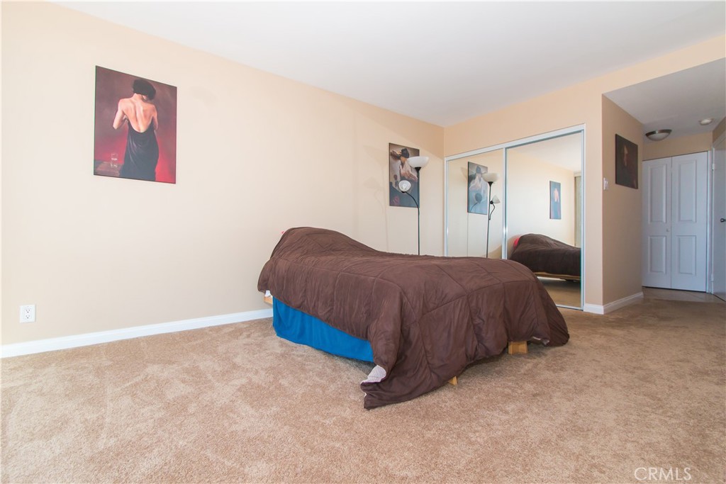 700 East Ocean Boulevard, Unit 706 Long Beach, CA 90802 - Photo 21 of 31 a bedroom with a bed and a painting on the wall