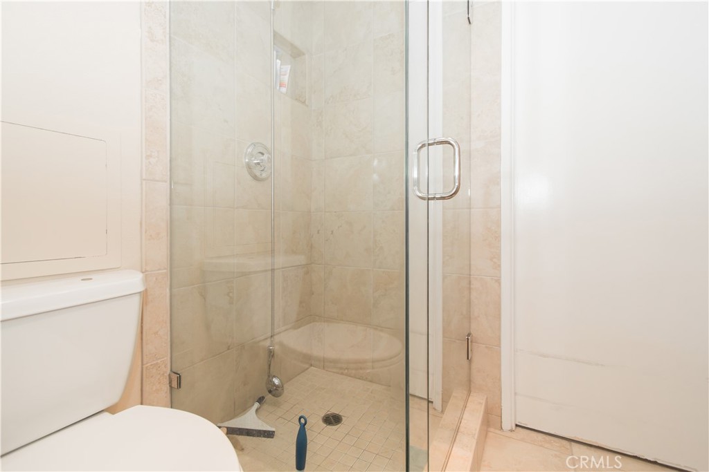 700 East Ocean Boulevard, Unit 706 Long Beach, CA 90802 - Photo 24 of 31 a bathroom with a granite countertop toilet and shower