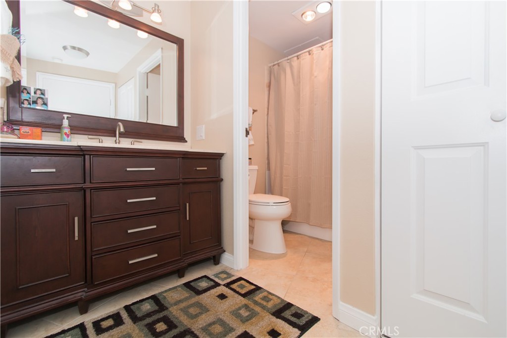700 East Ocean Boulevard, Unit 706 Long Beach, CA 90802 - Photo 28 of 31 a bathroom with a sink a toilet and a mirror