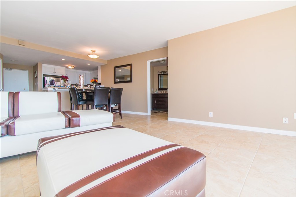 700 East Ocean Boulevard, Unit 706 Long Beach, CA 90802 - Photo 3 of 31 a living room with furniture and a dining table with kitchen view