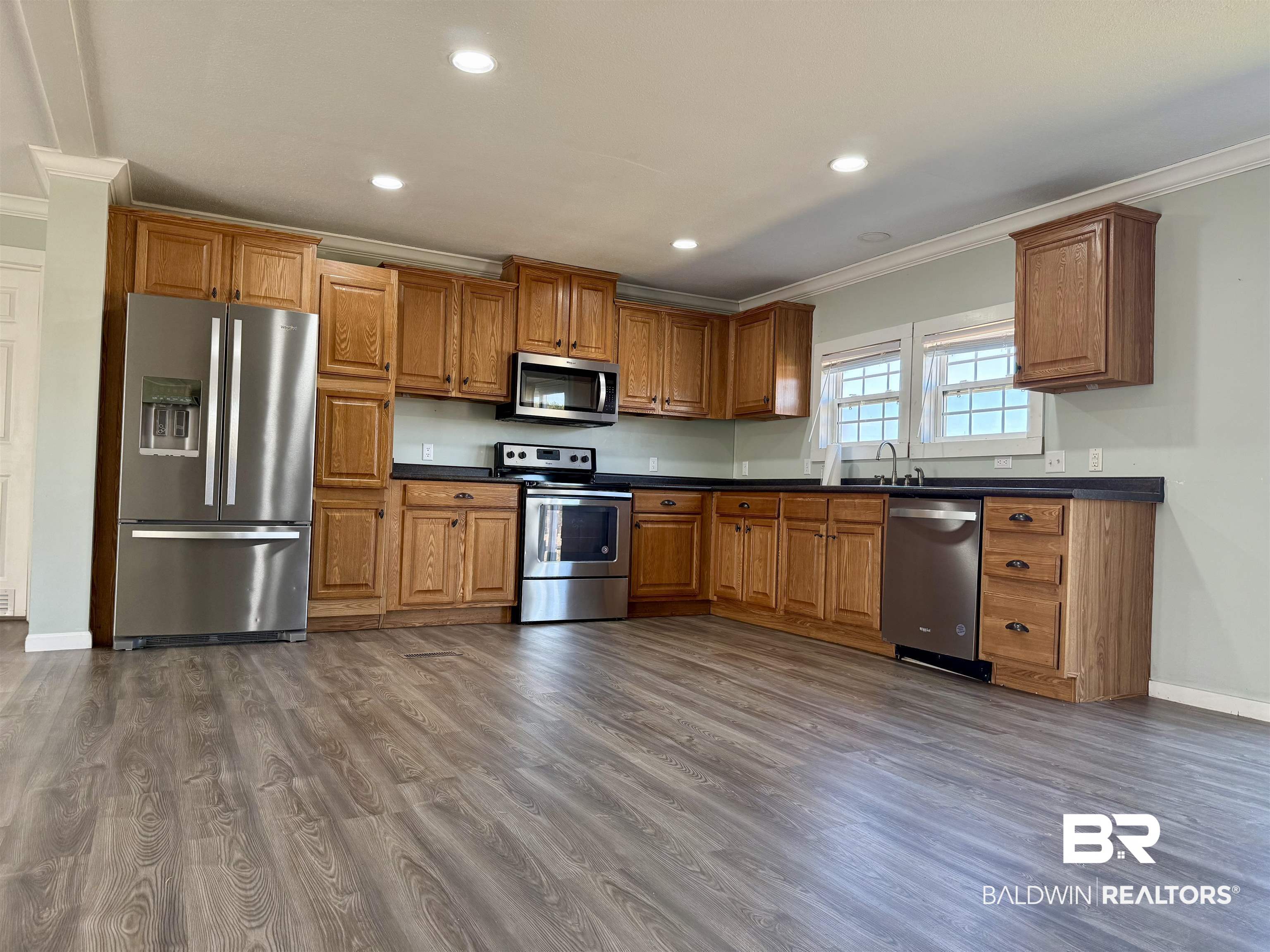 1064 Old Fannie Road Flomaton, AL 36441 - Photo 4 of 17 Kitchen with wood finish cabinets, stainless steel appliances, dark countertops, crown molding, and recessed lighting