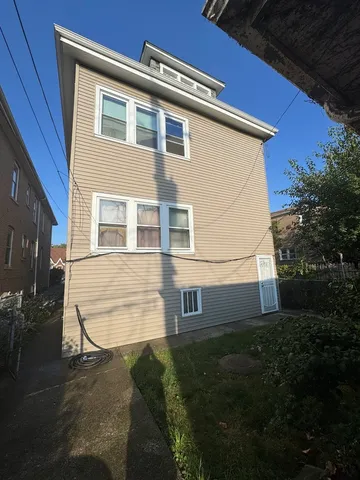 a view of house with backyard