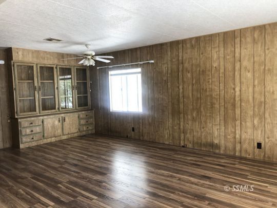 3713 Goat Ranch Road Mountain Mesa, CA 93240 - Photo 4 of 43 an empty room with wooden floor and windows