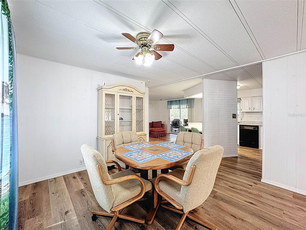 3249 Susan Drive Spring Hill, FL 34606 - Photo 17 of 60 a view of a dining room with furniture and wooden floor