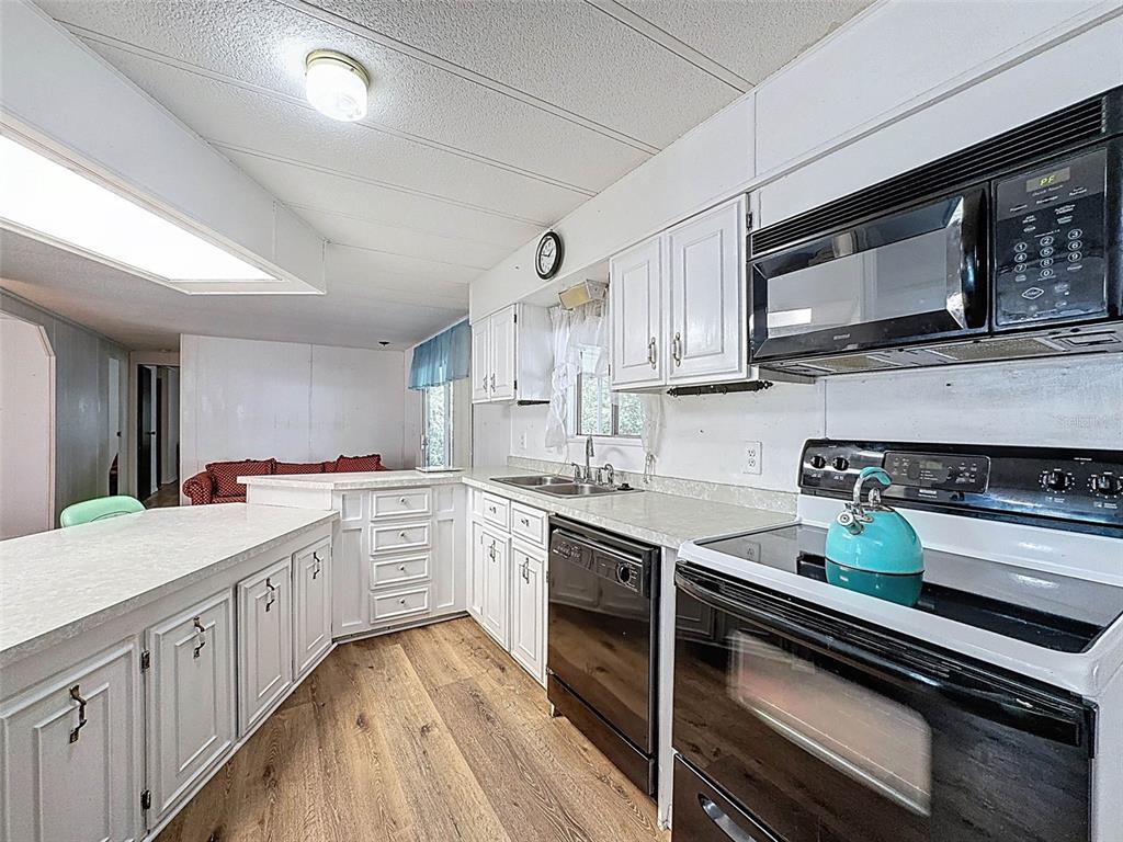 3249 Susan Drive Spring Hill, FL 34606 - Photo 21 of 60 a kitchen with a sink stove and microwave