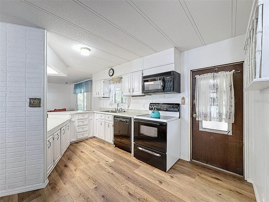 3249 Susan Drive Spring Hill, FL 34606 - Photo 25 of 60 a large kitchen with stainless steel appliances granite countertop a stove and a sink