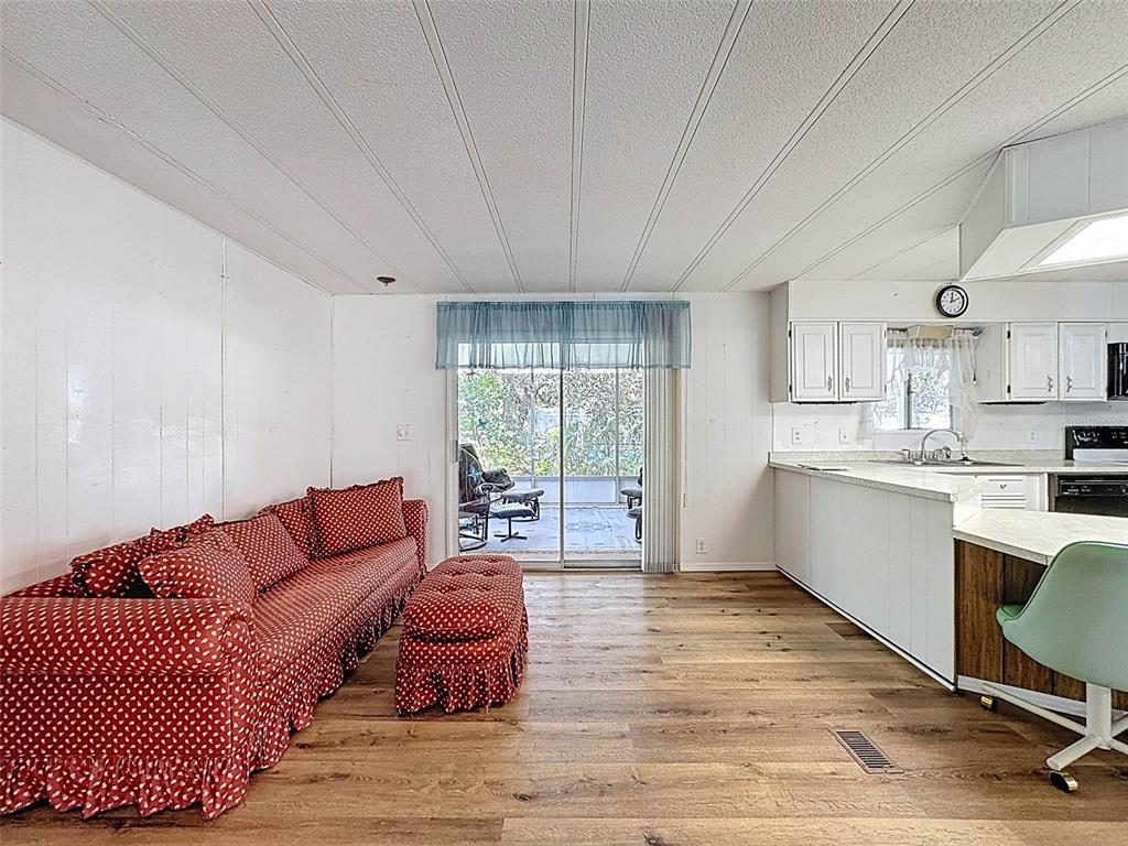 3249 Susan Drive Spring Hill, FL 34606 - Photo 27 of 60 a living room with a couch wooden floor and a large window