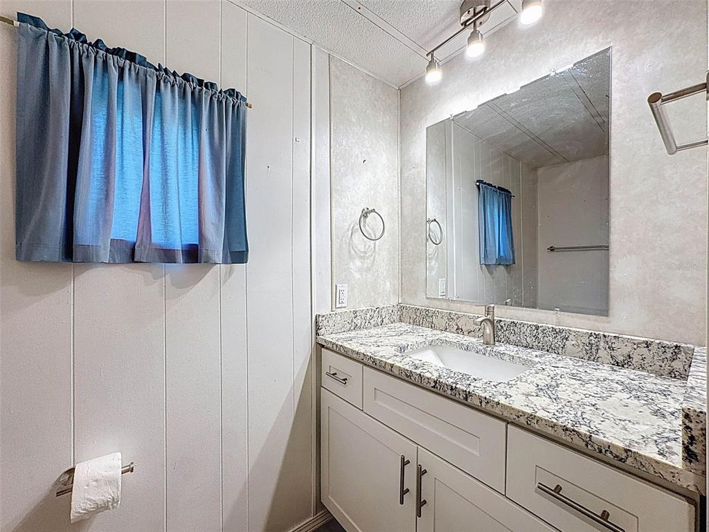 3249 Susan Drive Spring Hill, FL 34606 - Photo 34 of 60 a bathroom with a sink and a mirror