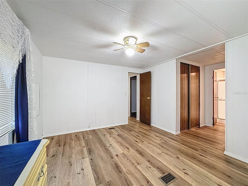 3249 Susan Drive Spring Hill, FL 34606 - Photo 37 of 60 a view of empty room with wooden floor and fan