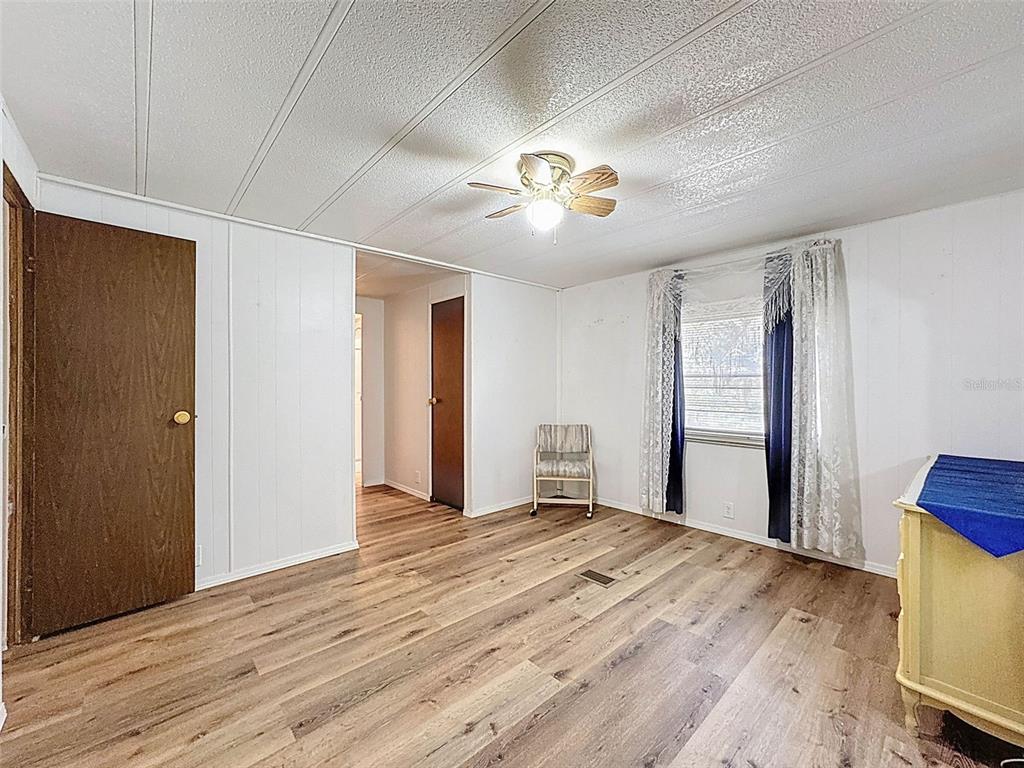 3249 Susan Drive Spring Hill, FL 34606 - Photo 38 of 60 a view of an empty room with wooden floor and a window
