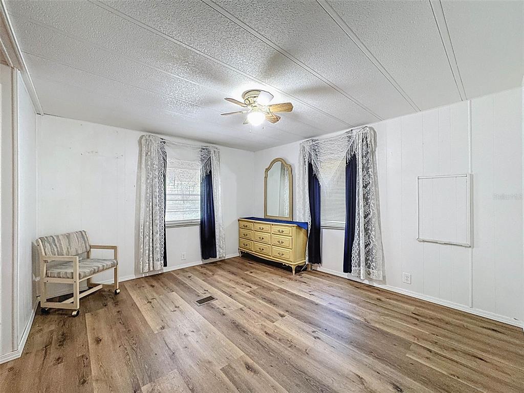 3249 Susan Drive Spring Hill, FL 34606 - Photo 39 of 60 a bedroom with a bed and a chandelier