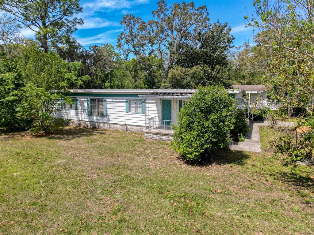 3249 Susan Drive Spring Hill, FL 34606 - Photo 52 of 60 a house with trees in front of it