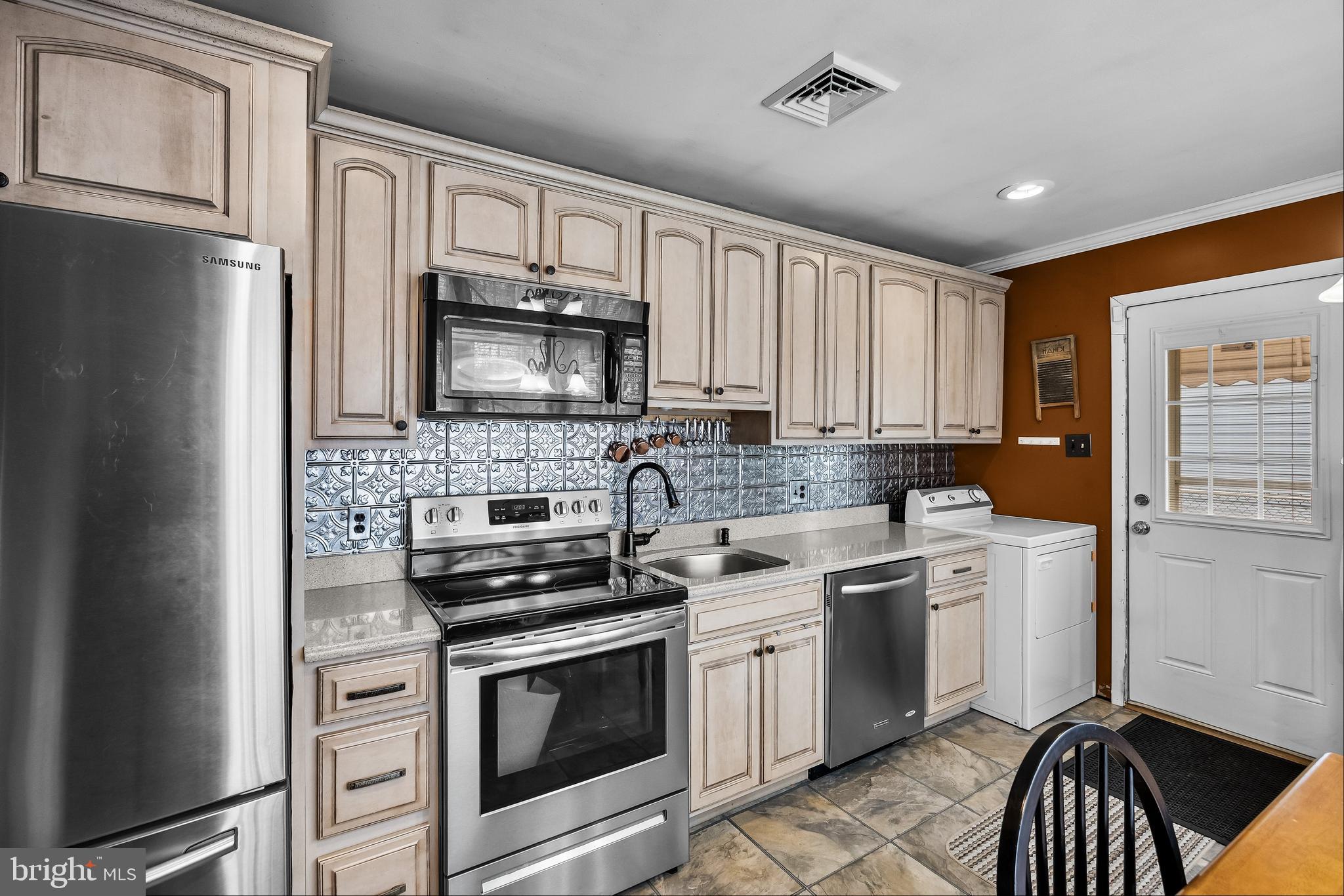 419 Delview Lane Delanco, NJ 08075 - Photo 6 of 21 a kitchen with a stove microwave and cabinets