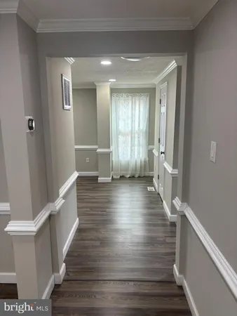 a view of a hallway view with wooden floor and staircase