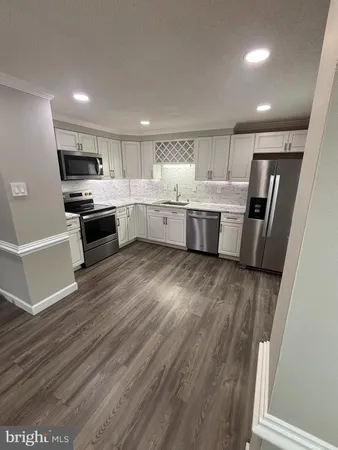 a kitchen with a white stove top oven and refrigerator