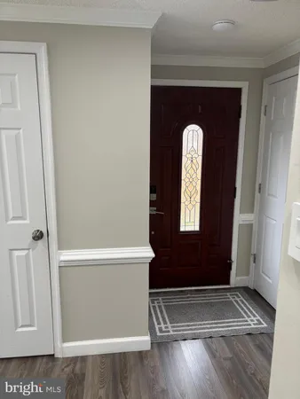 a view of front door with wooden floor