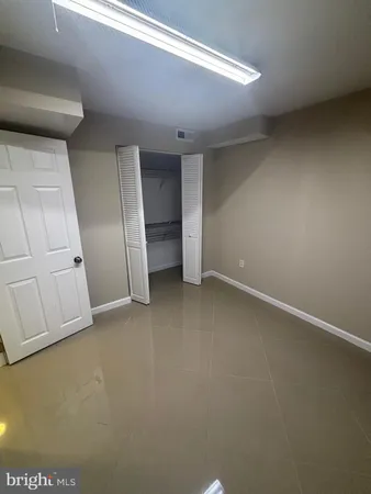 a view of an empty room with closet