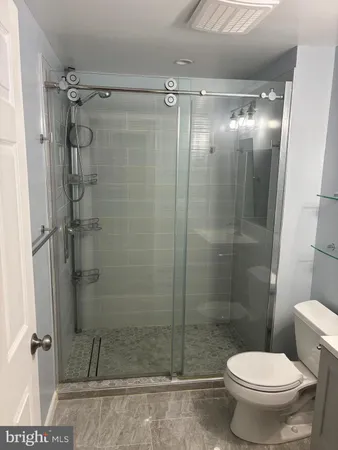 a bathroom with a shower and a toilet