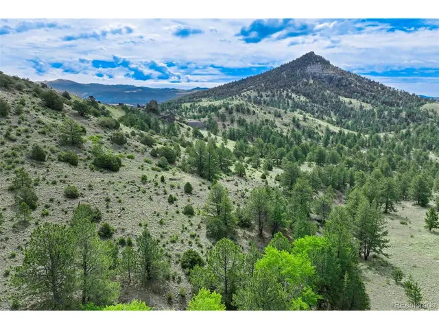 a view of a field with mountains in the background