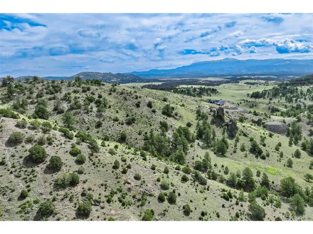 a view of a lush green hillside and a building
