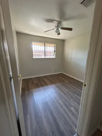 wooden floor in an empty room with a window