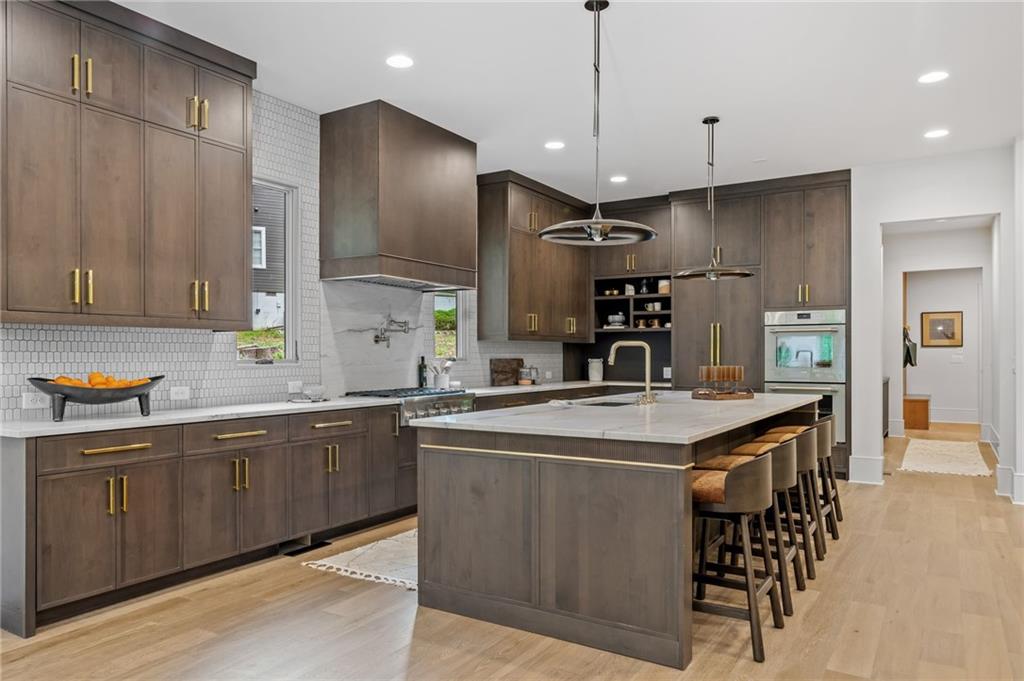 8455 Forsyth Commons Cumming, GA 30041 - Photo 3 of 10 a kitchen with stainless steel appliances granite countertop a sink a stove and a refrigerator