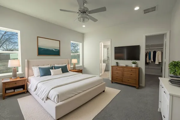 a bedroom with a bed and a flat screen tv