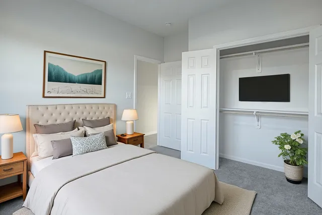 a bedroom with a bed and a flat screen tv