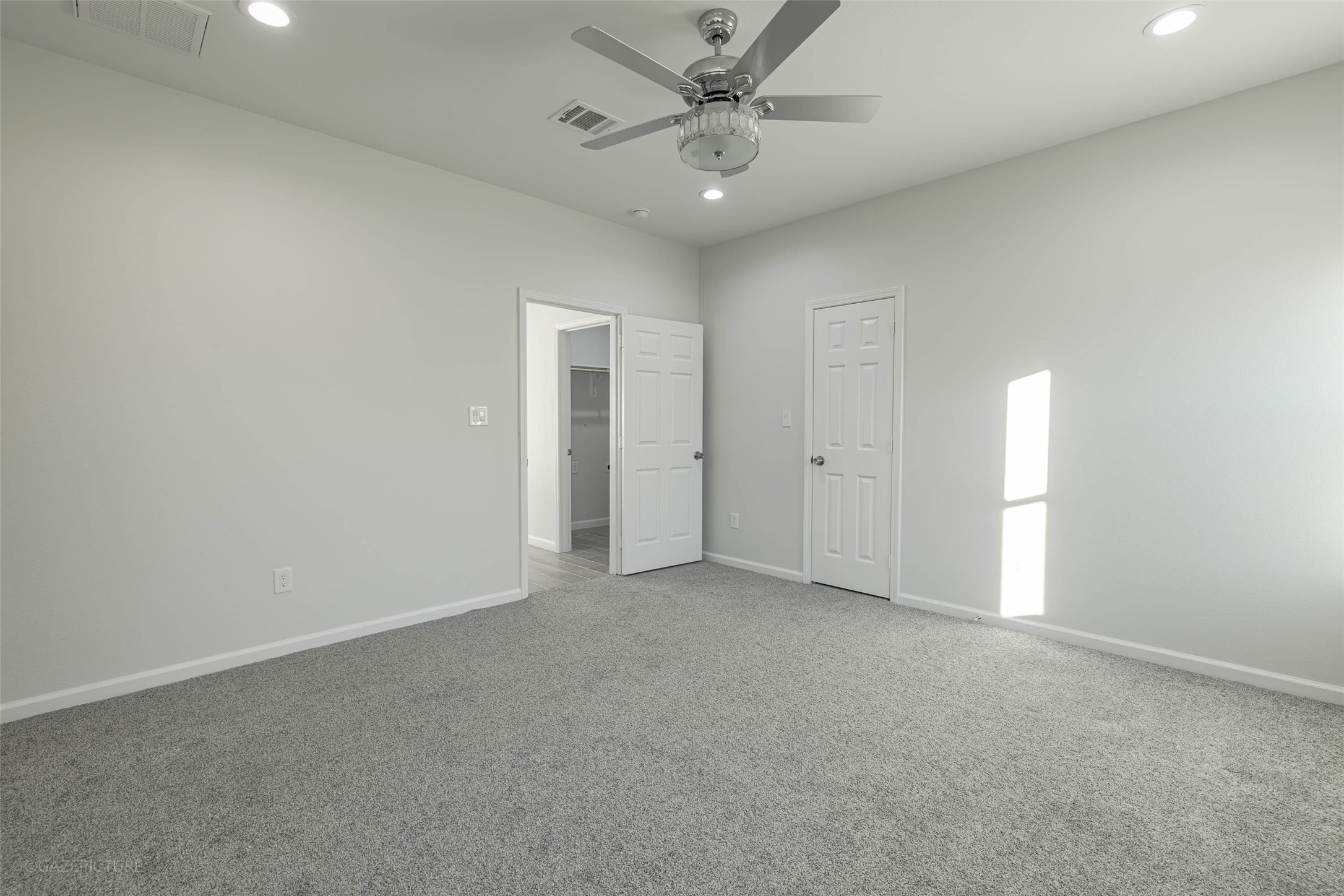 20733 Emerald Street Prairie View, TX 77484 - Photo 21 of 34 an empty room with chandelier fan and windows