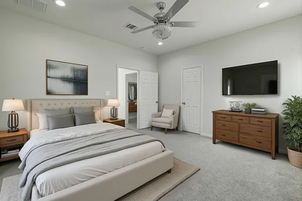 a bedroom with a bed and a flat screen tv