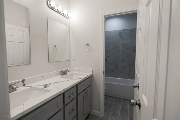 a bathroom with a granite countertop sink mirror and double