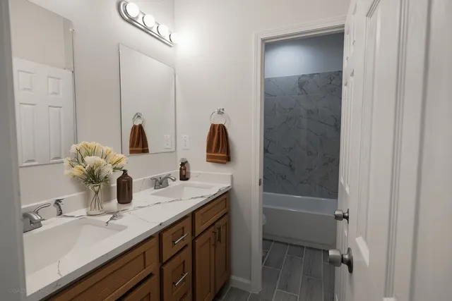 a bathroom with double vanity sink and a mirror
